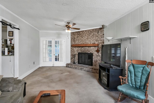 living room featuring a fireplace, crown molding, carpet, and ceiling fan