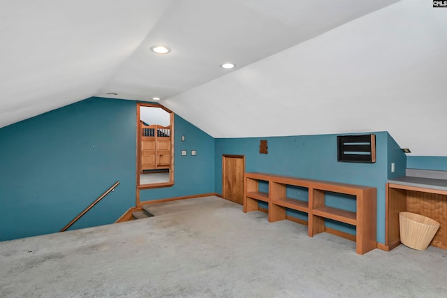 bonus room with vaulted ceiling and carpet