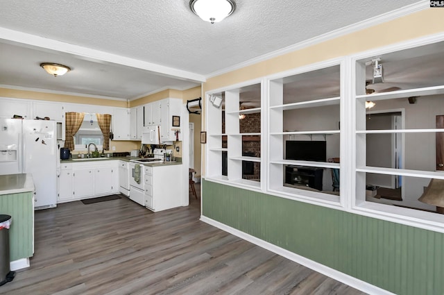 kitchen featuring white appliances, dark wood-type flooring, sink, white cabinets, and a textured ceiling