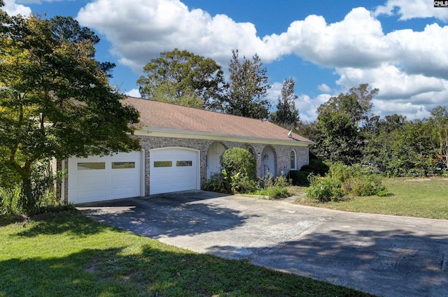 ranch-style home featuring a garage and a front yard