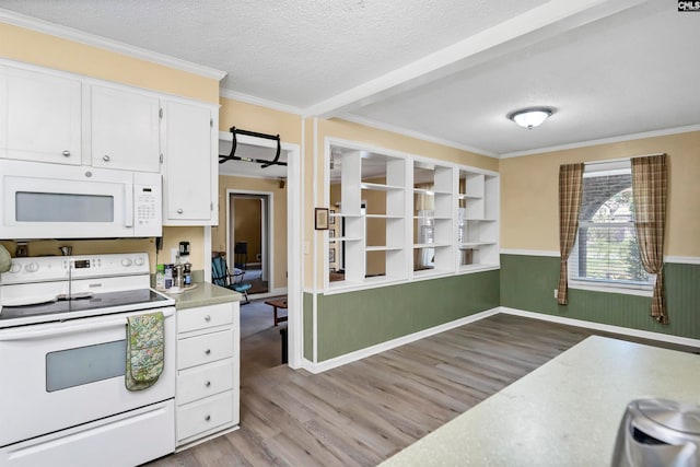 kitchen featuring white appliances, light hardwood / wood-style floors, white cabinets, and a textured ceiling