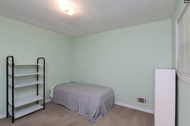 carpeted bedroom with a textured ceiling