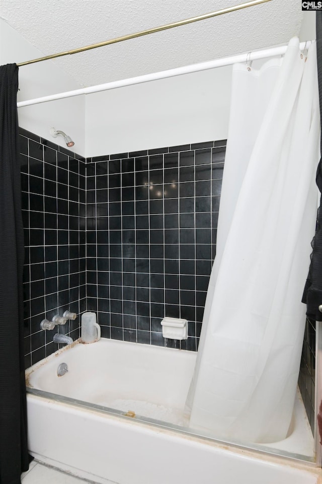 bathroom with shower / bath combo with shower curtain