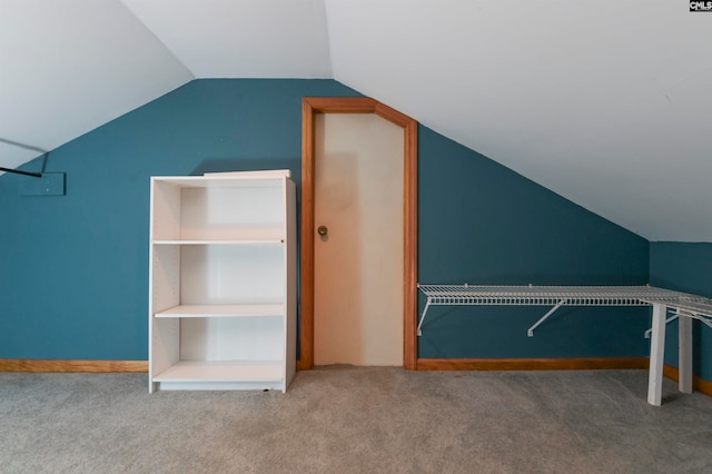 walk in closet with carpet flooring and vaulted ceiling