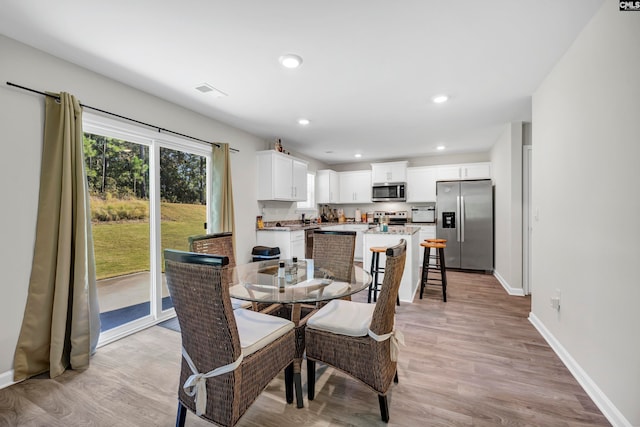 dining space featuring light hardwood / wood-style flooring