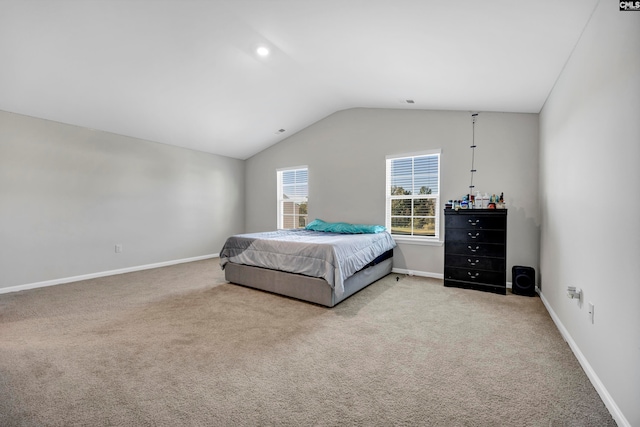 carpeted bedroom with lofted ceiling