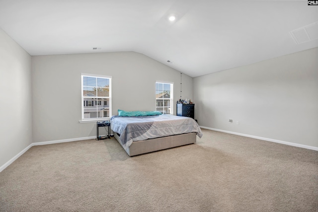 carpeted bedroom featuring vaulted ceiling