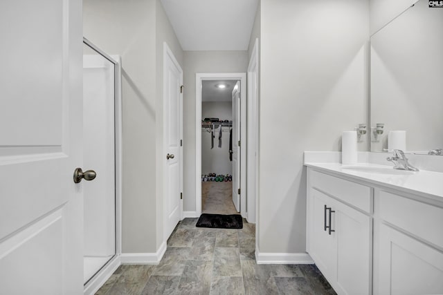 bathroom with vanity and a shower with shower door