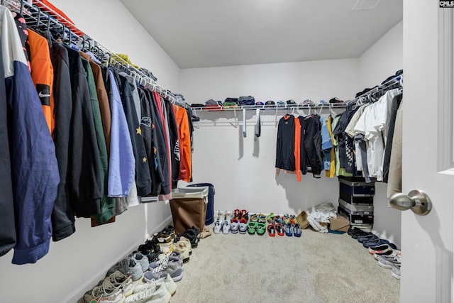 walk in closet featuring carpet flooring