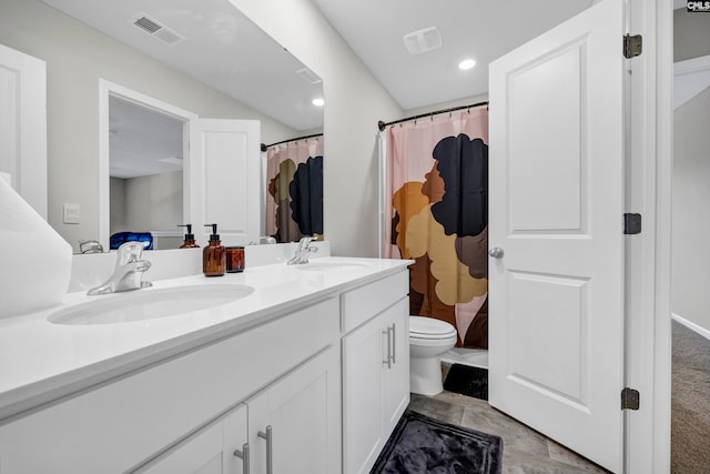 bathroom featuring toilet, walk in shower, and vanity