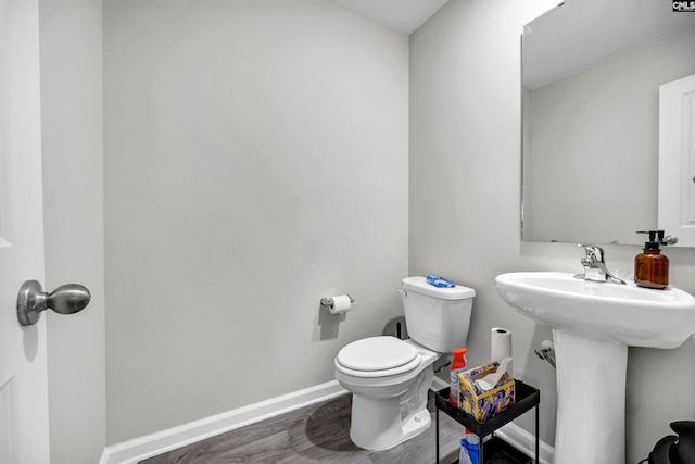 bathroom featuring sink, hardwood / wood-style flooring, and toilet