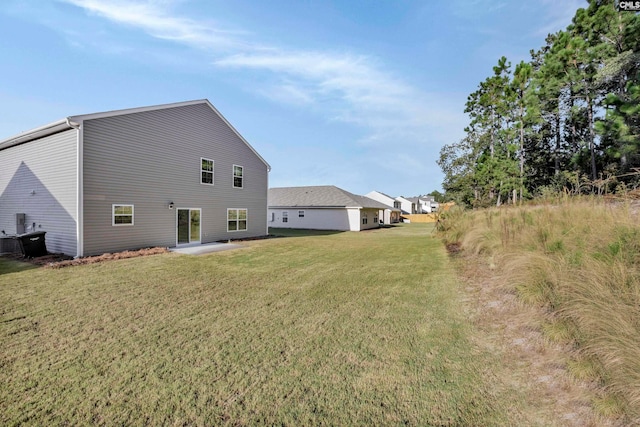 back of house featuring a yard and a patio