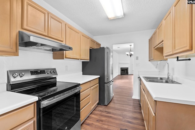 kitchen featuring dark wood-type flooring, sink, a textured ceiling, light brown cabinets, and stainless steel appliances