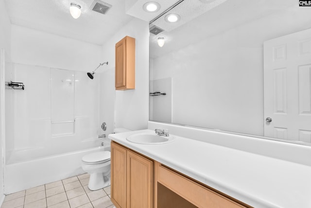 full bathroom featuring tile patterned floors, bathtub / shower combination, toilet, a textured ceiling, and vanity