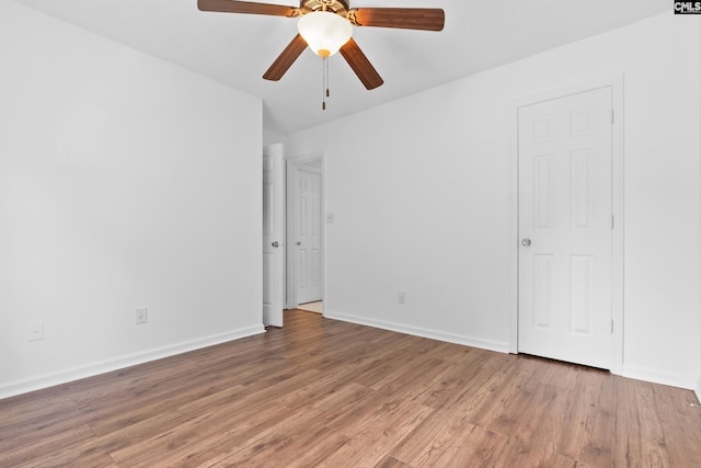 unfurnished room with hardwood / wood-style flooring and ceiling fan