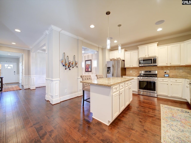 kitchen with plenty of natural light, appliances with stainless steel finishes, and a kitchen island