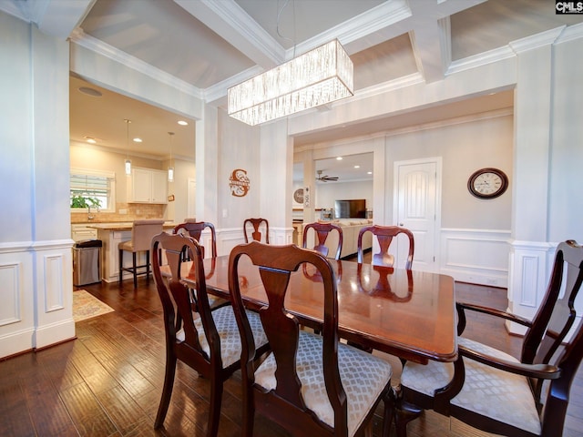 dining room featuring ornamental molding, an inviting chandelier, and dark hardwood / wood-style floors