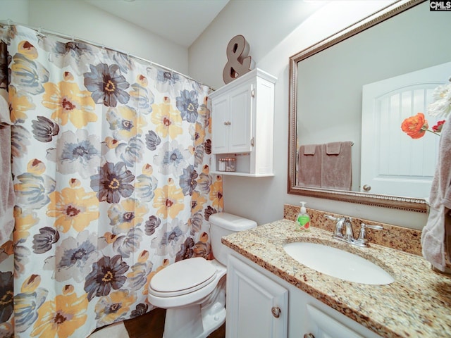 bathroom featuring walk in shower, vanity, and toilet