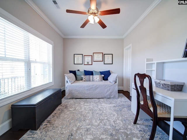 bedroom with ceiling fan, crown molding, and hardwood / wood-style floors