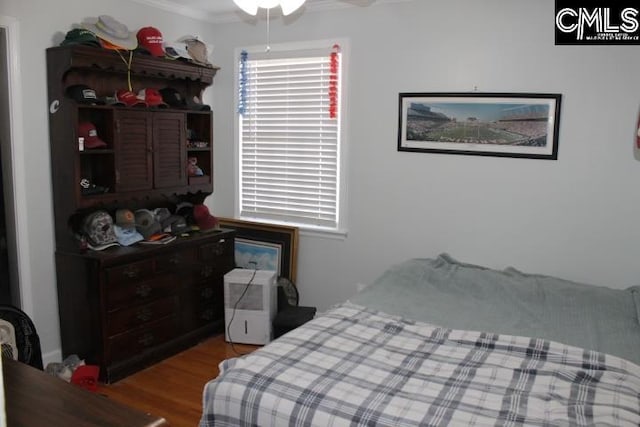 bedroom with light hardwood / wood-style flooring and ornamental molding