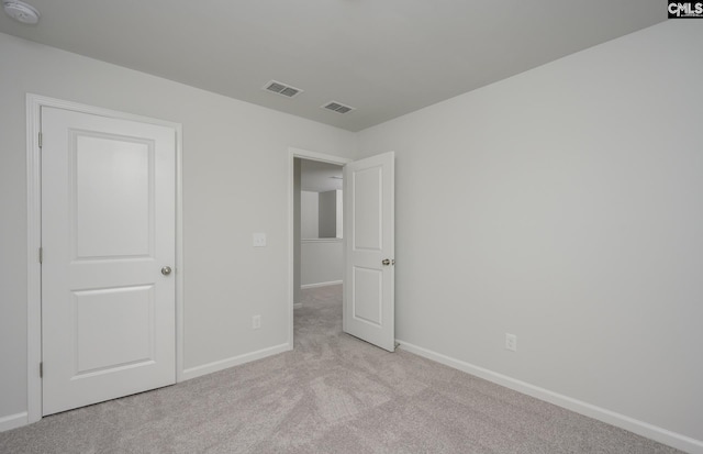 unfurnished bedroom featuring light colored carpet