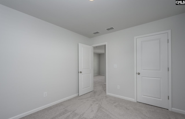 unfurnished bedroom with light colored carpet