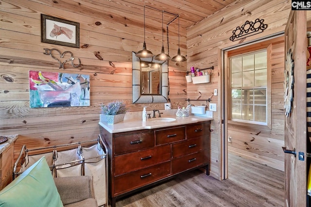 bathroom with vanity, wood walls, hardwood / wood-style floors, and wooden ceiling