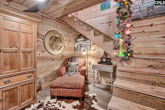 sitting room with wooden walls, wood ceiling, and dark hardwood / wood-style flooring