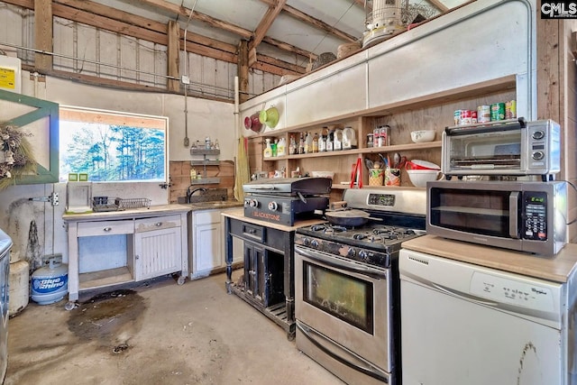 kitchen with appliances with stainless steel finishes, sink, and white cabinetry