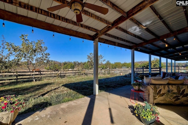 view of patio featuring ceiling fan and a rural view