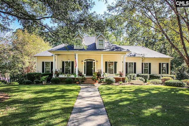 cape cod house featuring a front lawn and a porch