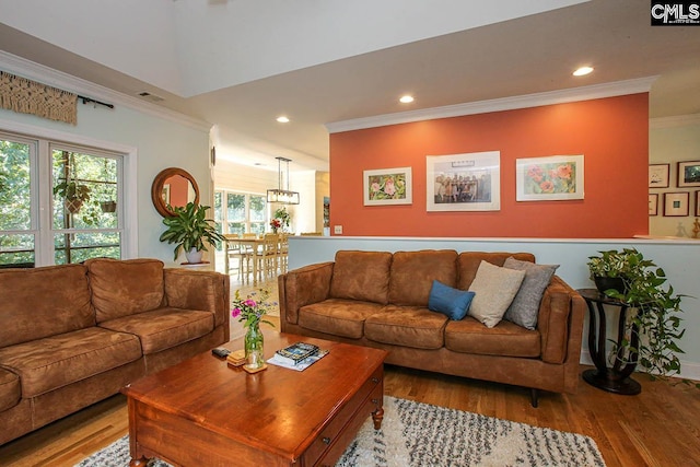 living room featuring light hardwood / wood-style floors and ornamental molding