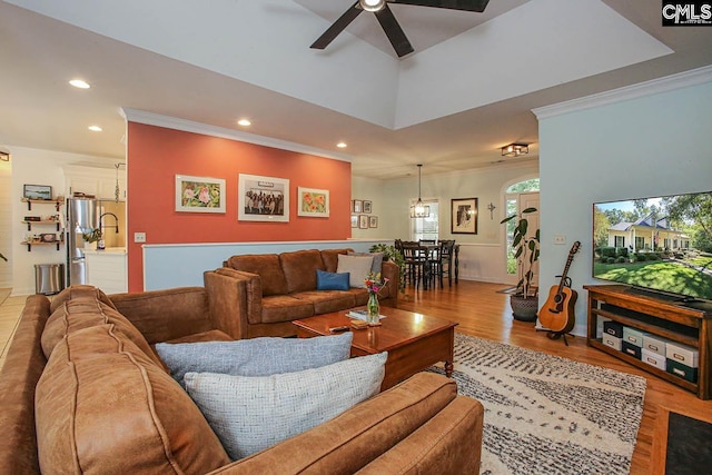 living room featuring ceiling fan, hardwood / wood-style flooring, and ornamental molding