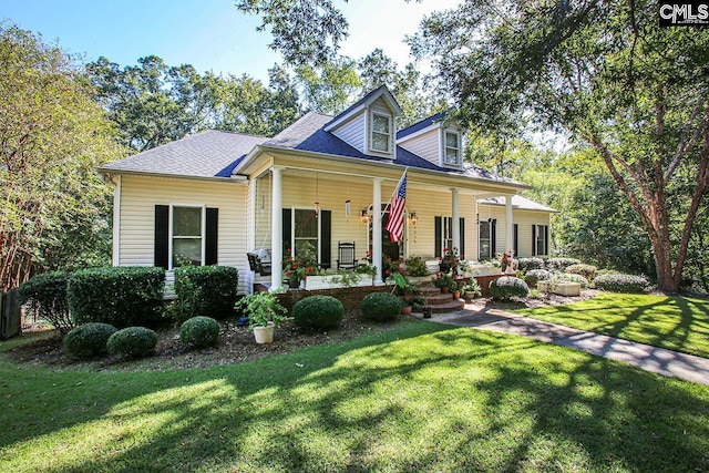 cape cod home featuring a front yard and a porch