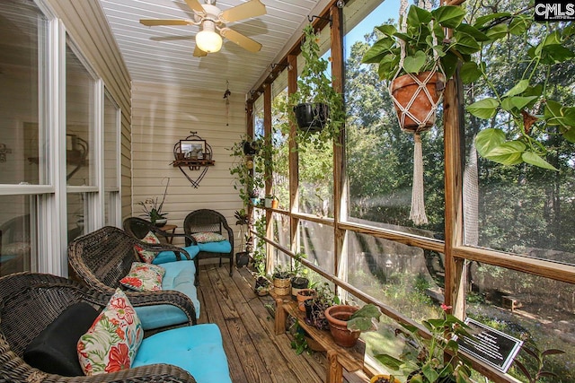 unfurnished sunroom featuring ceiling fan, plenty of natural light, and wooden ceiling