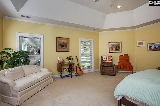 bedroom with a raised ceiling, light carpet, ornamental molding, and ceiling fan