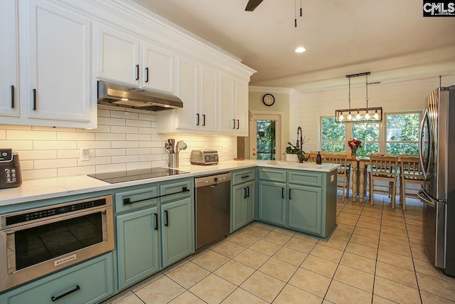 kitchen featuring stainless steel appliances, light tile patterned flooring, pendant lighting, white cabinetry, and backsplash