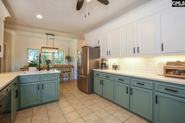 kitchen with light tile patterned flooring, pendant lighting, crown molding, white cabinetry, and dishwasher