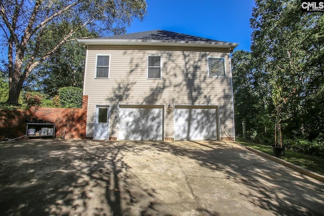 rear view of house with a garage