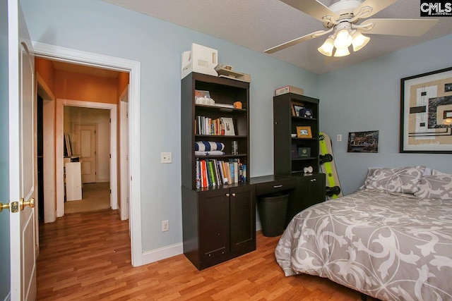 bedroom with ceiling fan and light hardwood / wood-style floors