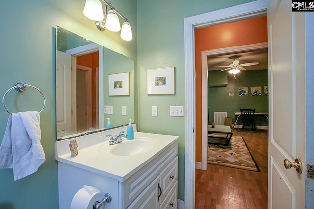 bathroom with wood-type flooring, vanity, and ceiling fan