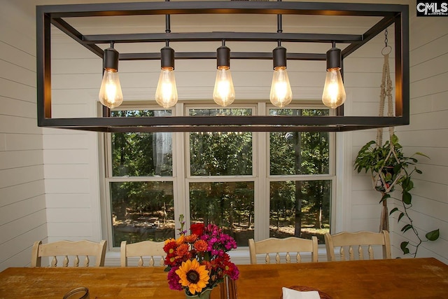 dining space with wood walls