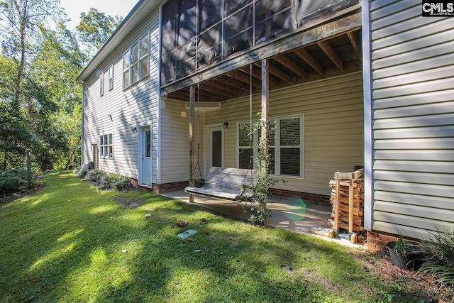 back of house featuring a patio and a lawn