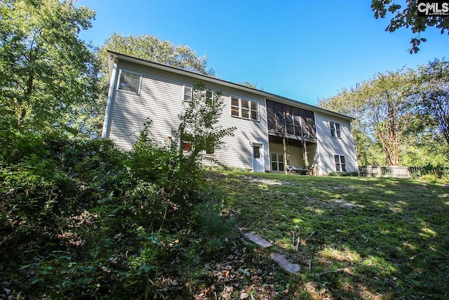 back of house featuring a yard