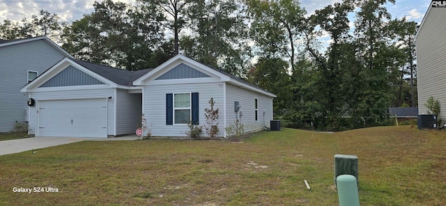 view of front of home with a front yard, cooling unit, and a garage