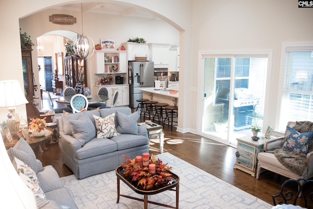 living room featuring dark wood-type flooring and a chandelier