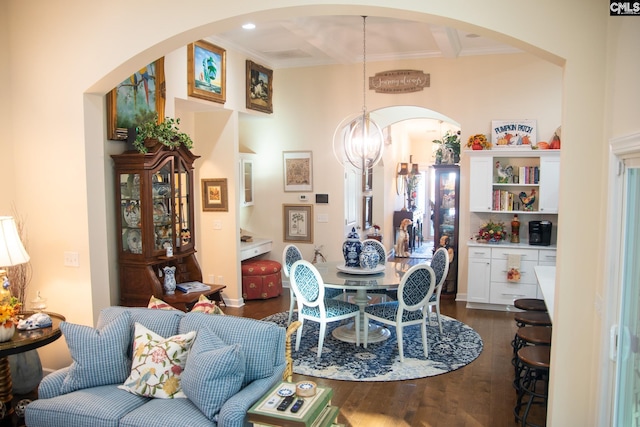 dining room featuring coffered ceiling, a notable chandelier, crown molding, and dark hardwood / wood-style flooring