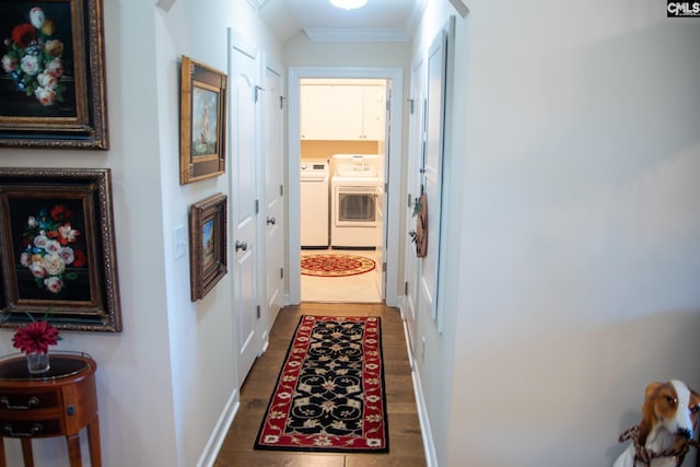 corridor featuring ornamental molding and separate washer and dryer