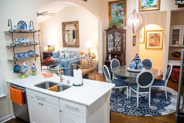 kitchen featuring white cabinets, lofted ceiling, sink, stainless steel dishwasher, and dark hardwood / wood-style floors