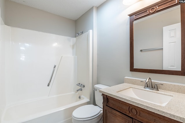 full bathroom featuring a textured ceiling, vanity, toilet, and  shower combination